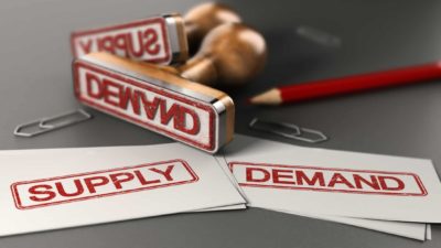 Two stamps with 'supply' and 'demand' written on them