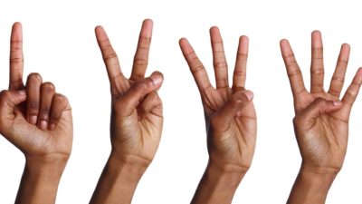 four hands making numbers one through four representing 4 asx shares to buy