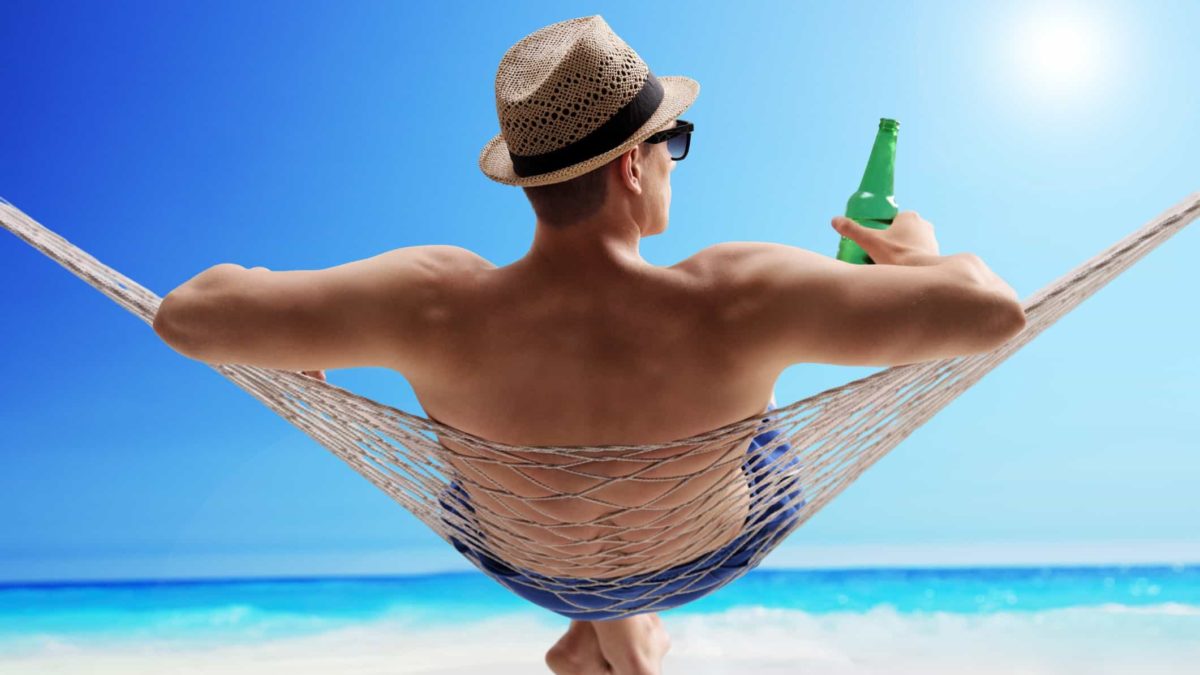 man sitting in hammock on beach representing asx shares to buy for retirement