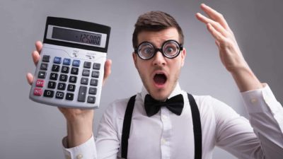 Liar loan ASX banks banker with calculator tries to make sense of the Big Four banks, indicating tough time ahead for banking shares