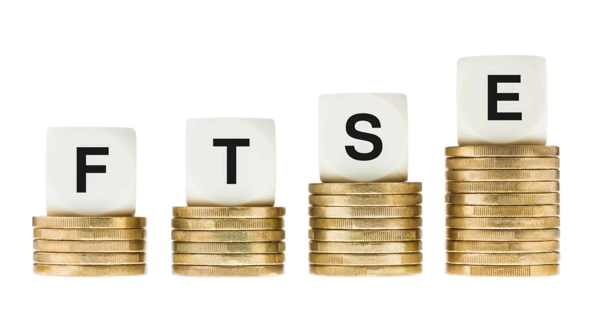 letter blocks spelling FTSE sitting atop growing piles of coins representing FTSE ETF