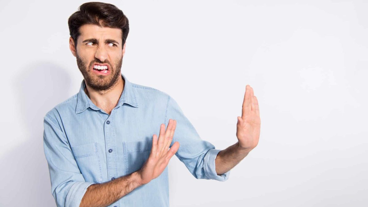 Turning down AGL shares represented by man placing hands up in front of him and frowning