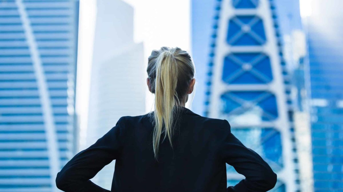 Back os ASX 200 woman executive looking out high rise office window