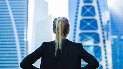 Back os ASX 200 woman executive looking out high rise office window