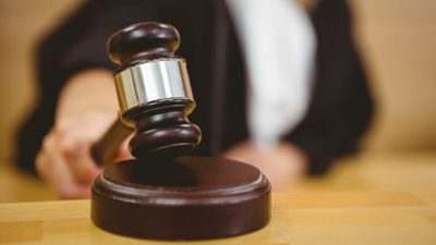 A judge's gavel is shown in a close up shot to represent ACMA's finding that Telstra put customers in danger