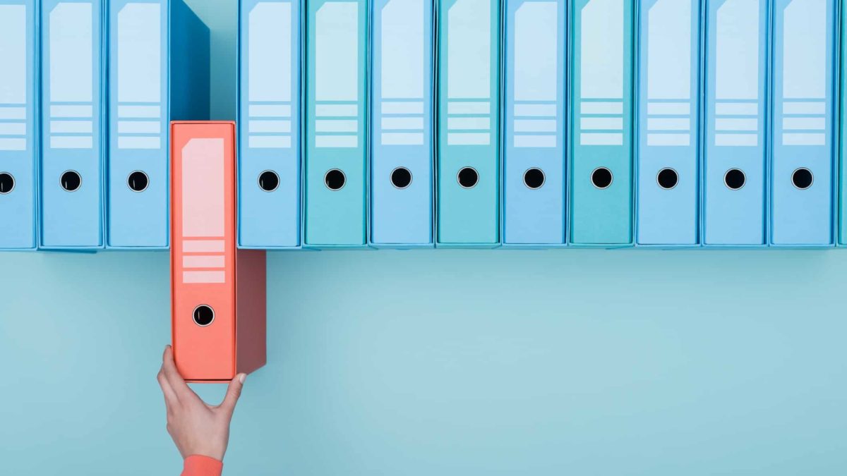 asx share portfolio of expert investor represented by hand removing a folder from shelf