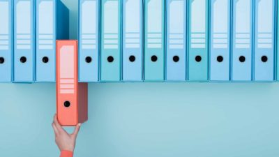 asx share portfolio of expert investor represented by hand removing a folder from shelf