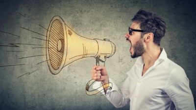 man holding a megaphone and shouting for people to invest in asx shares