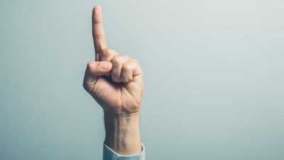 one asx share represented by a hand holding up one finger