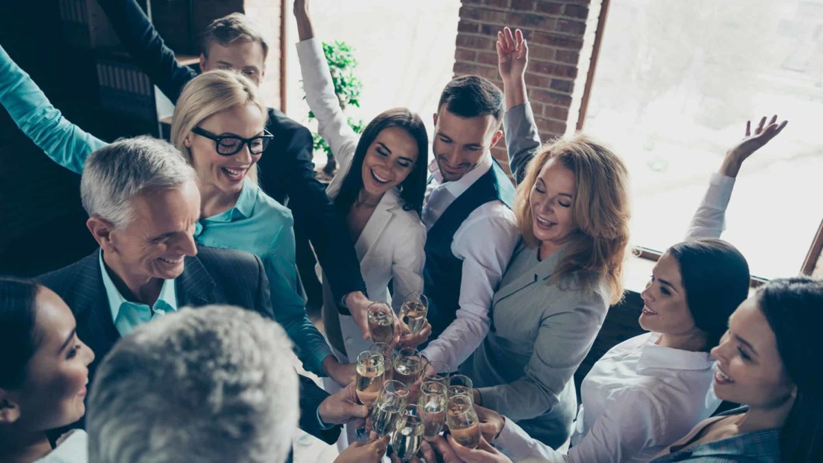 A group of ASX investors celebrating increasing share price with champagne.