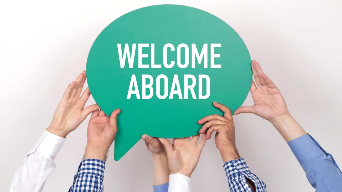 asx share initial public offering or IPO represented by hands holding up sign saying welcome aboard