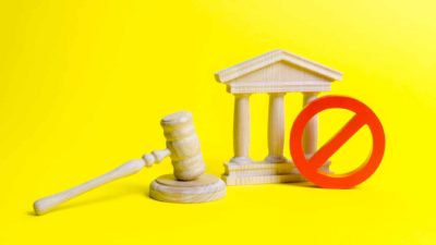 asx shares in trading halt represented by stop symbol next to judge's wooden hammer