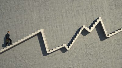 A man climbing stairs that go up and down in a chart style, indicating a moving share price