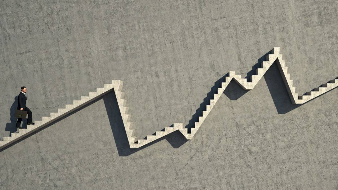 A man climbing stairs that go up and down in a chart style, indicating a moving share price