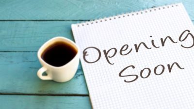 ASX 200 reopening plan A shop sign next to a cup of coffee saying opening soon, indicating a company back in business on the share market