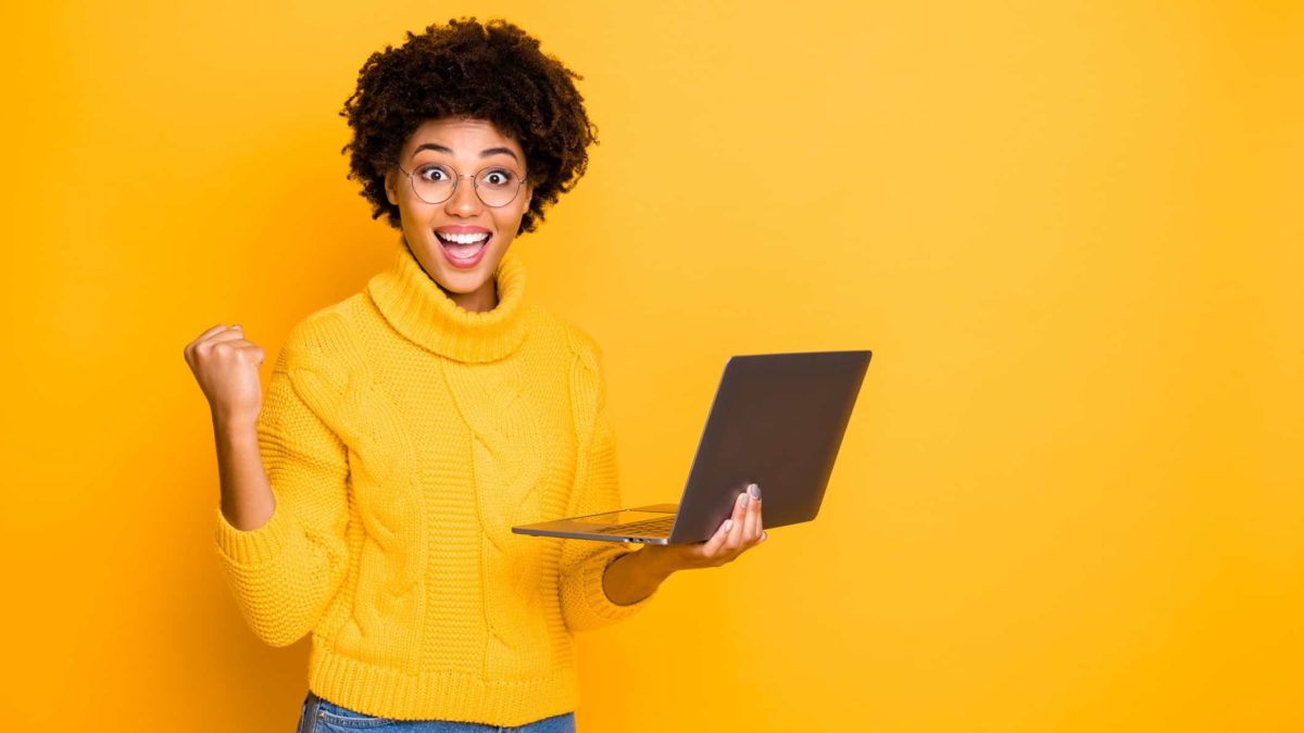Rising asx share price represented by woman with excited expression holding laptop