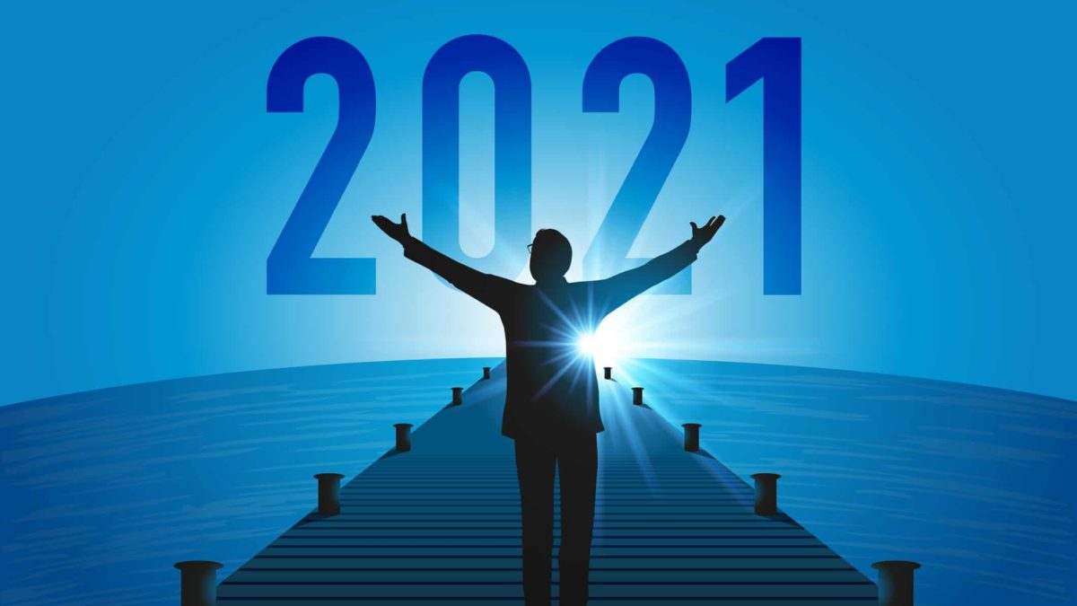 Share price outlook a man raise his arms to the sun as it rises with the year 2021 in the background, indicating a bright future on the ASX share market