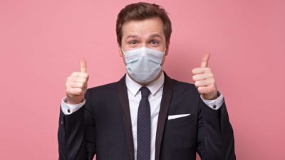 covid asx share price represented by man in face mask giving thumbs up