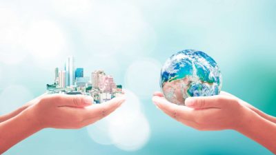 world's biggest companies represented by one person holding cityscape and another holding earth in hands