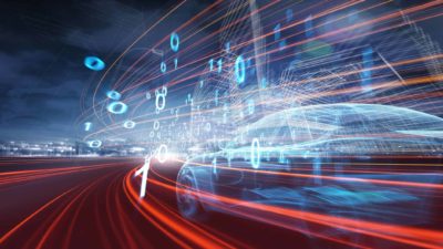 A futuristic view of electric vehicle technology with speeding bright light trails indicating power.