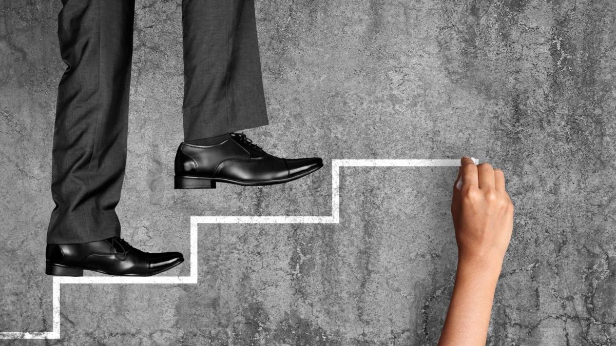 feet of investor like warren buffett walking up chalk-drawn steps