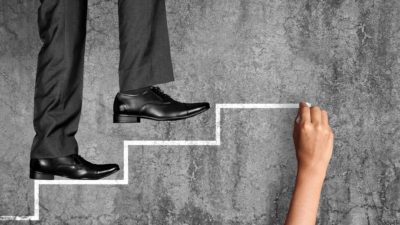 feet of investor like warren buffett walking up chalk-drawn steps