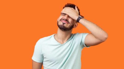 Investment regret represented by an asx shares investor slapping his forehead