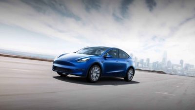 tesla model Y electric vehicle driving along road