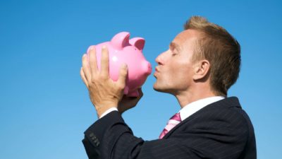 Deterra share price royalties top asx shares represented by investor kissing piggy bank