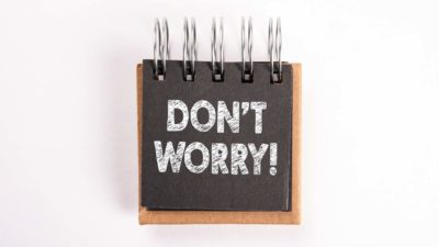 A notebook sign saying 'Don't Worry!'