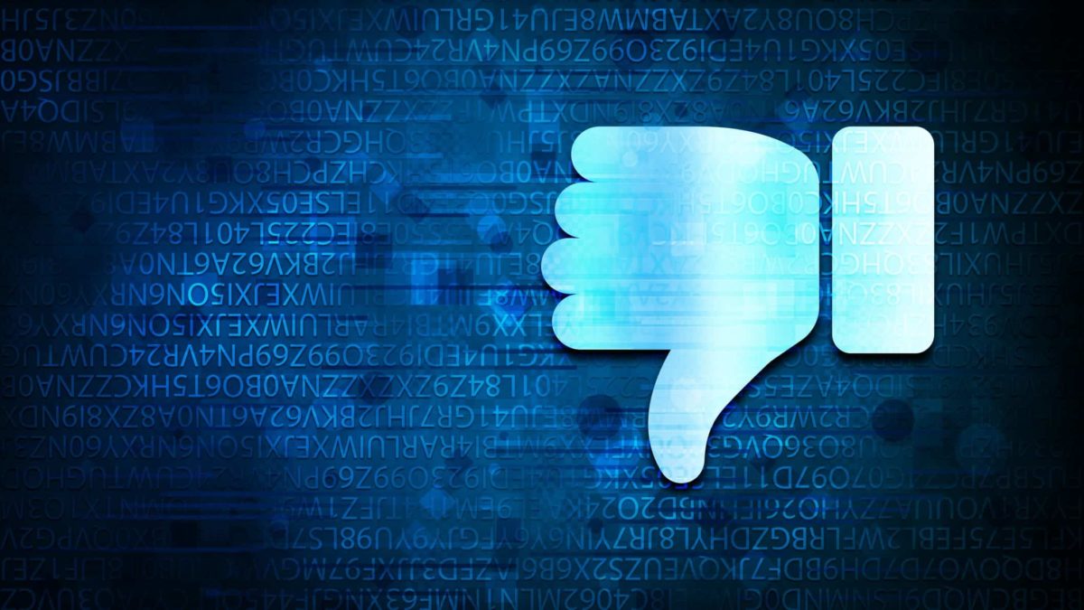 Thumbs down Facebook icon over dark screen