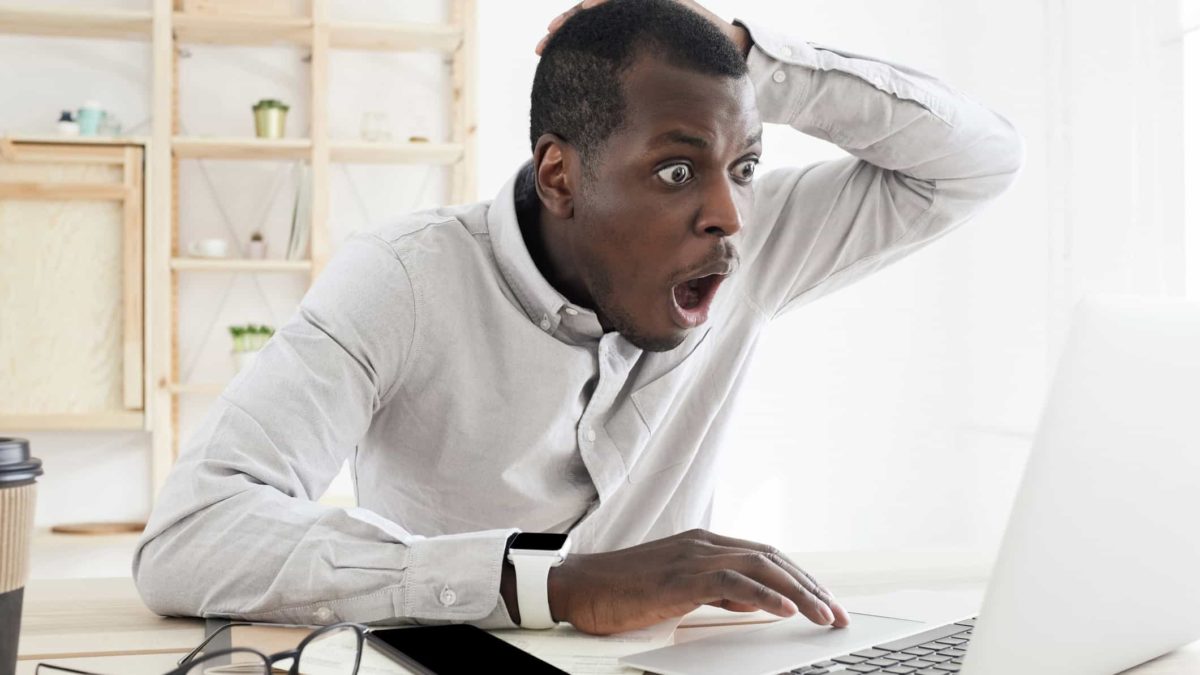 An ASX investor looks devastated as he watches his computer screen, indicating bad news