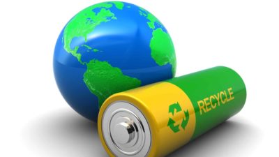 giant battery represented by battery next to world globe