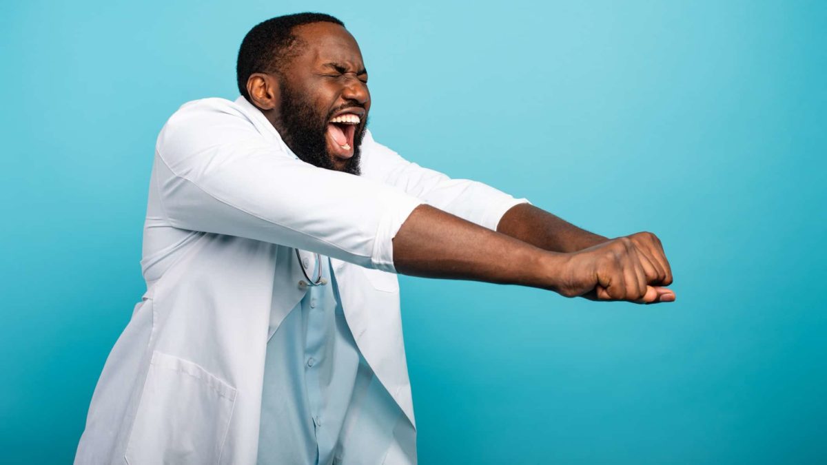 A happy doctor in a white coat dancing due to his excitement over the EBOS acquisition