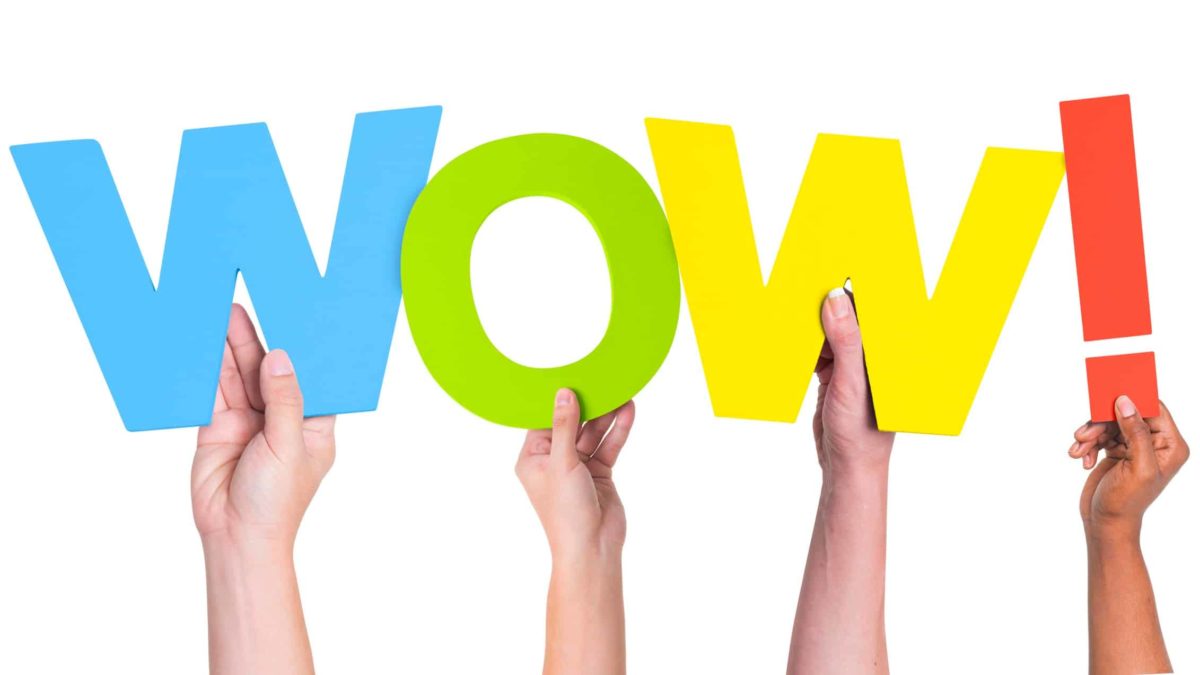 Woolworth share price upgrade response to asx share price represented by hands holding up the word wow