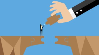 A graphic shows a big hand holding a puzzle piece handing it to a small figure in order to bridge a gap, indicating a share price rescue scheme