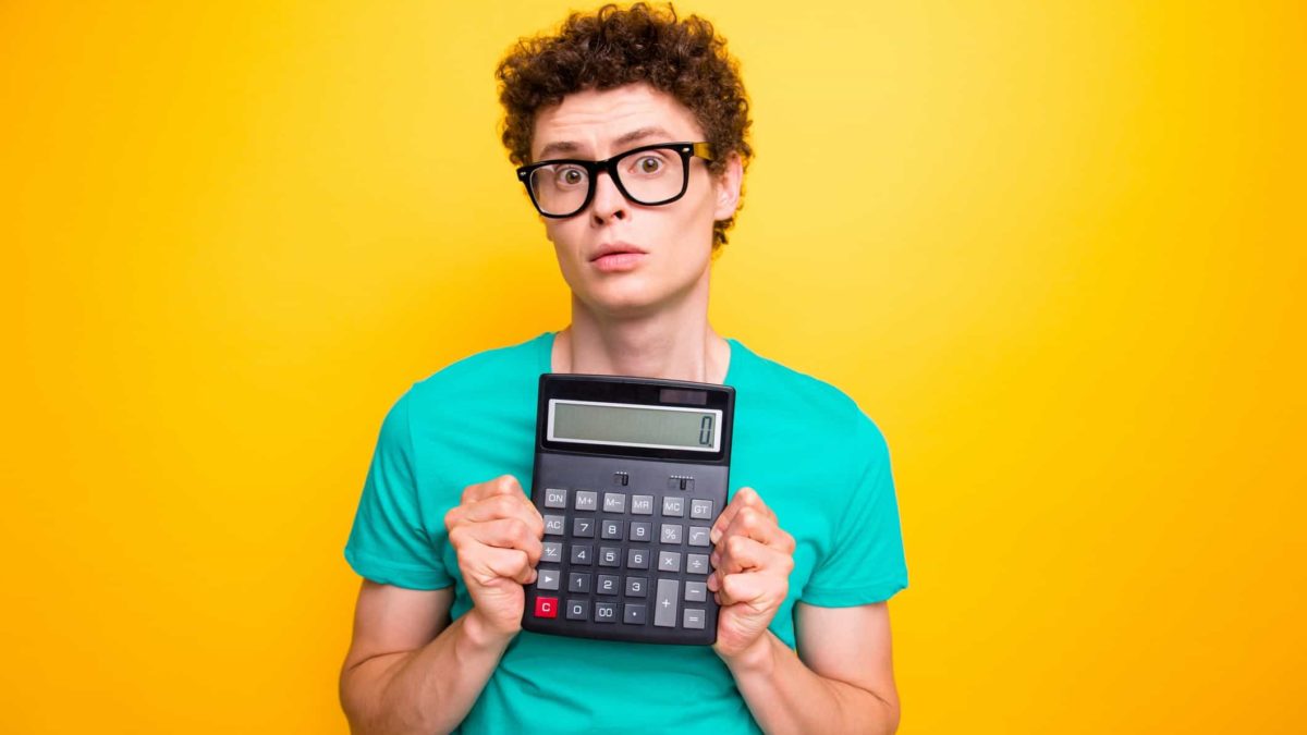 falling asx share price and profits represented by investor holding calculator with zero on screen