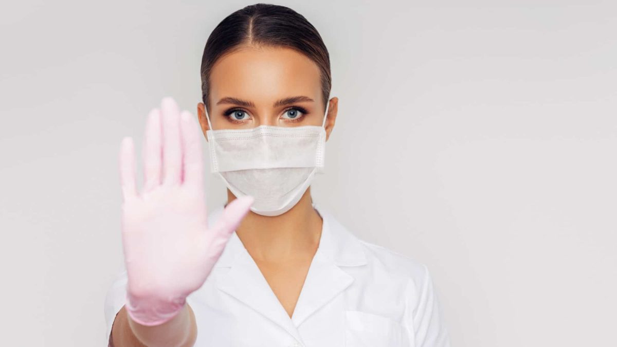 pause in medical asx share price represented by doctor holding hand up in stop motion