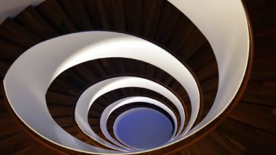 A black and white vortex dragging down, indicating share holders falling into a rotation trap