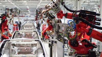 Tesla stock represented by inside of the Tesla factory at work