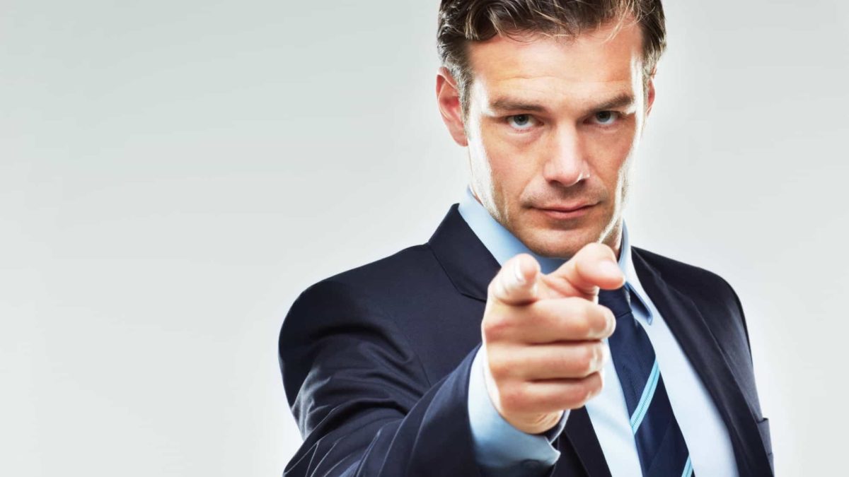 A businessman points a finger in accusation, indicating a share price or ASX company in trouble
