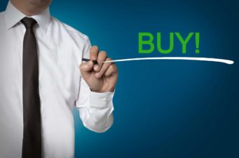 ASX shares Business man marking buy on board and underlining it