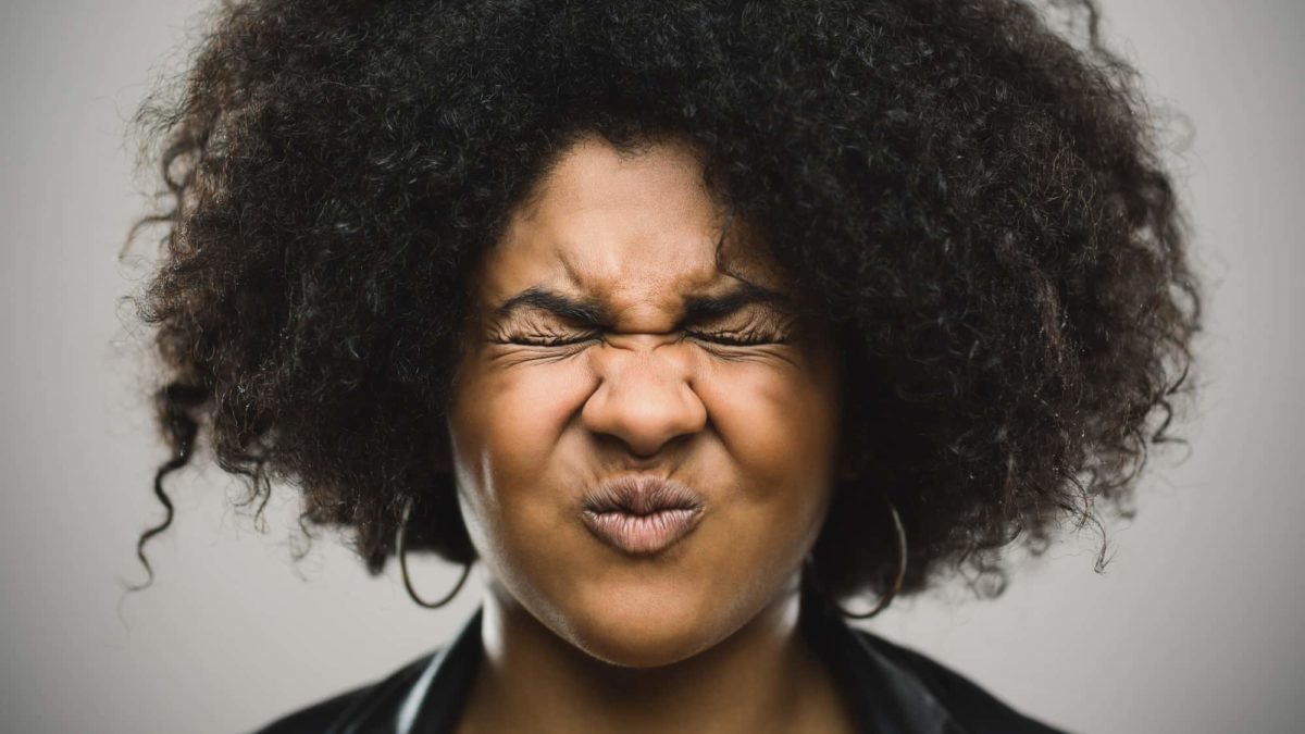 A woman with big hair reacts in shock, indicating a massive share prise fall