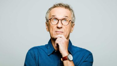 A mature aged man looks unsure, indicating uncertainty around a share price