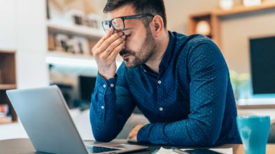 Investor looking dismayed at computer screen with falling asx share price