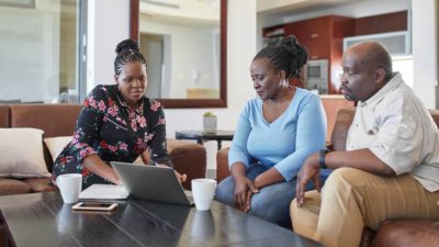 a person guiding a couple on how to invest