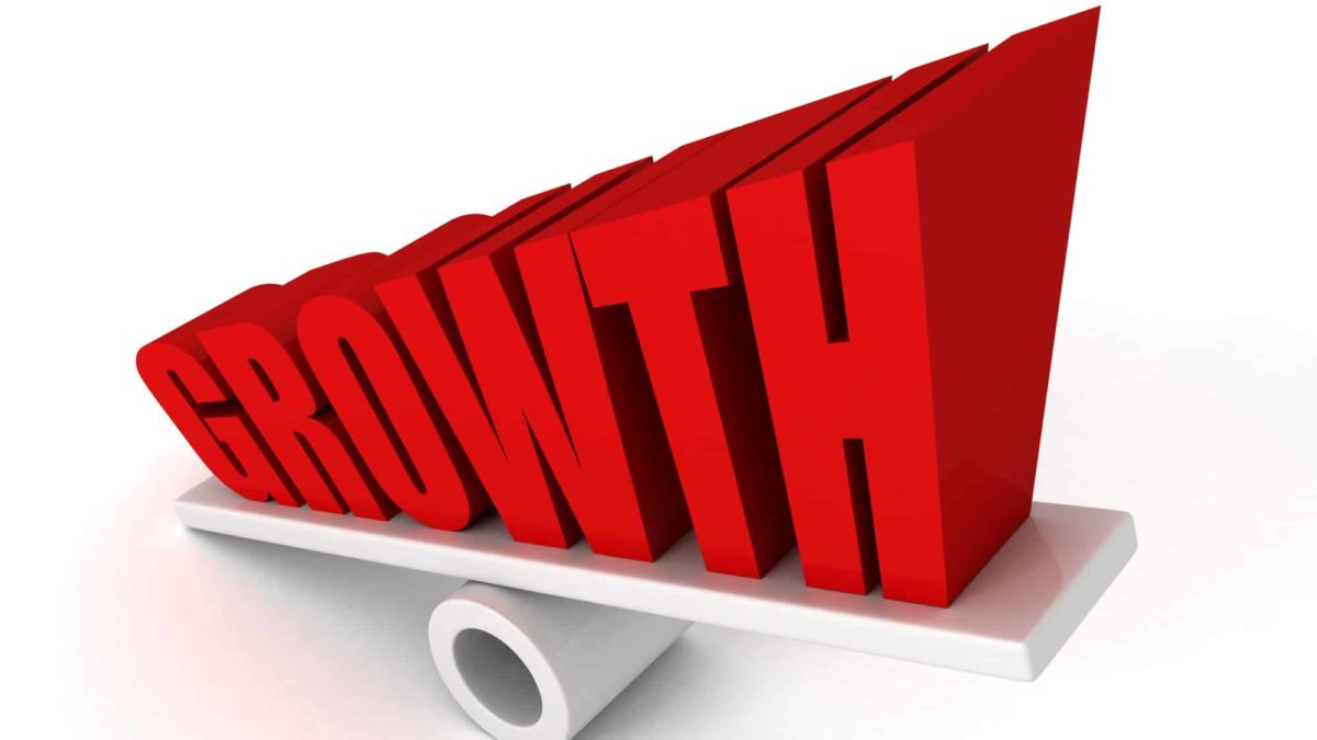 Big red letters on a seesaw spell growth, indicating share price movements for ASX growth shares