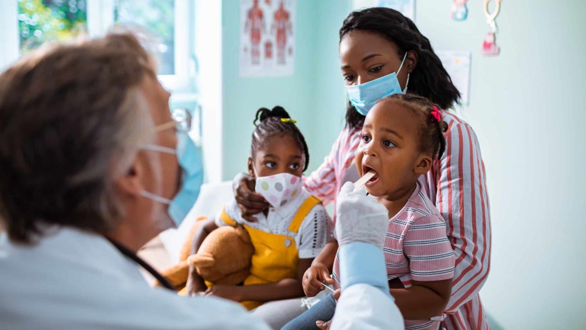 Mother and young children at doctors