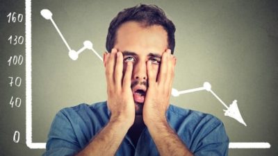 shocked man with hands over his face with a declining graph in background representing falling CleanSpace share price