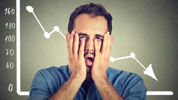 shocked man with hands over his face with a declining graph in background representing falling CleanSpace share price